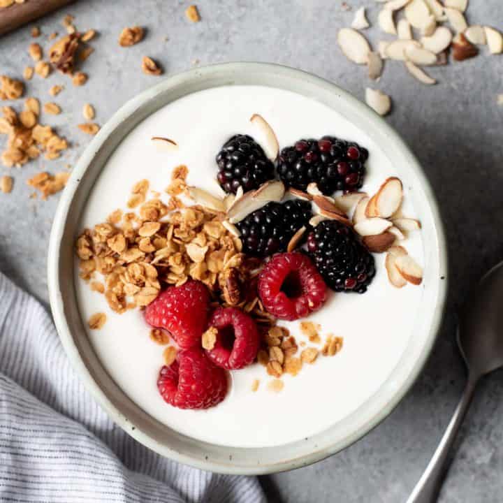 Overhead shot of 24-hour yogurt in a bowl, topped with granola and berries