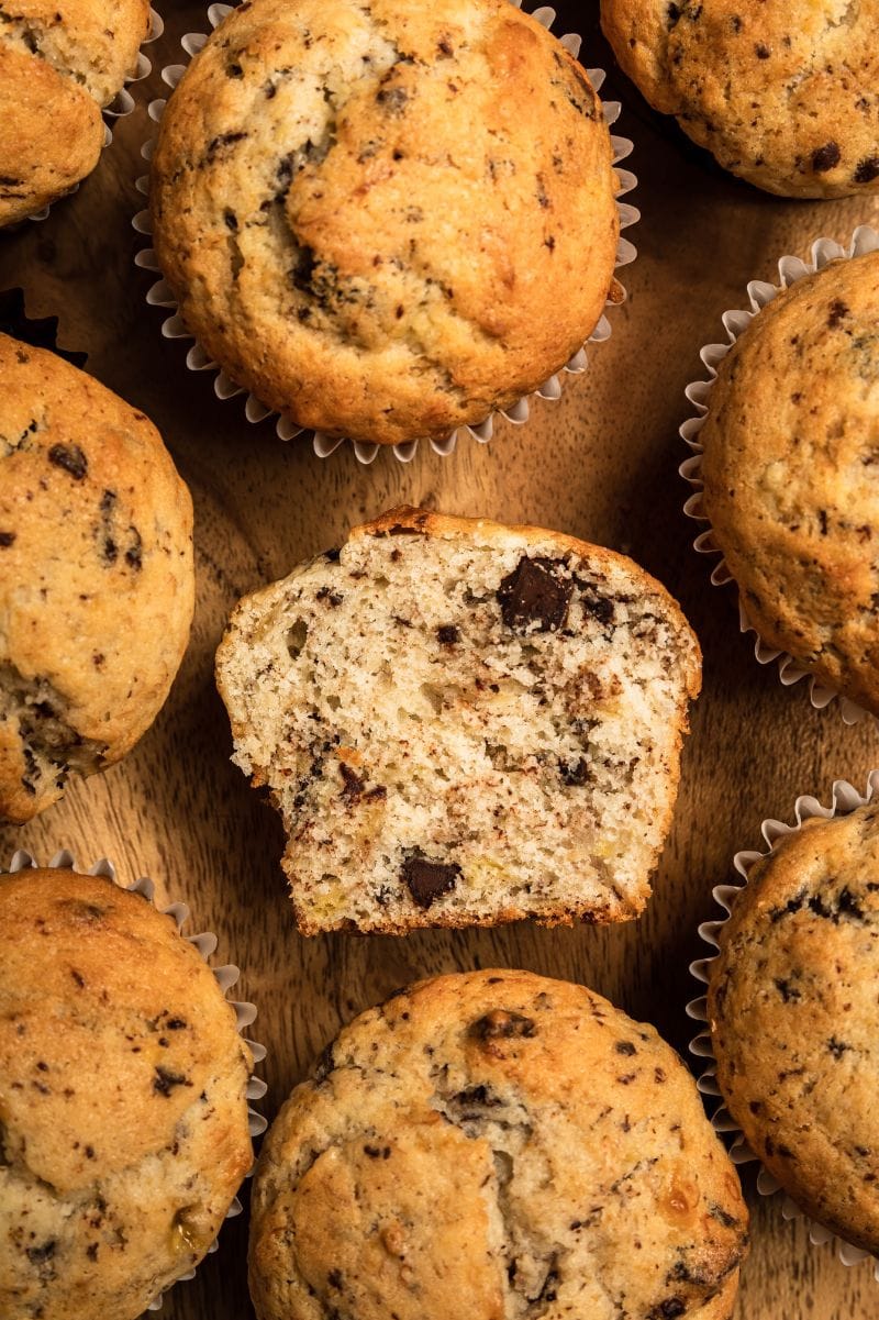 Tight view of the inside crumb of an almond flour banana muffin half, surrounded by fluffy muffin tops.