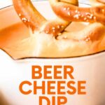 Close view of a pretzel dunked into a small pot of beer cheese dip. A text overlay reads, "Beer Cheese Dip."