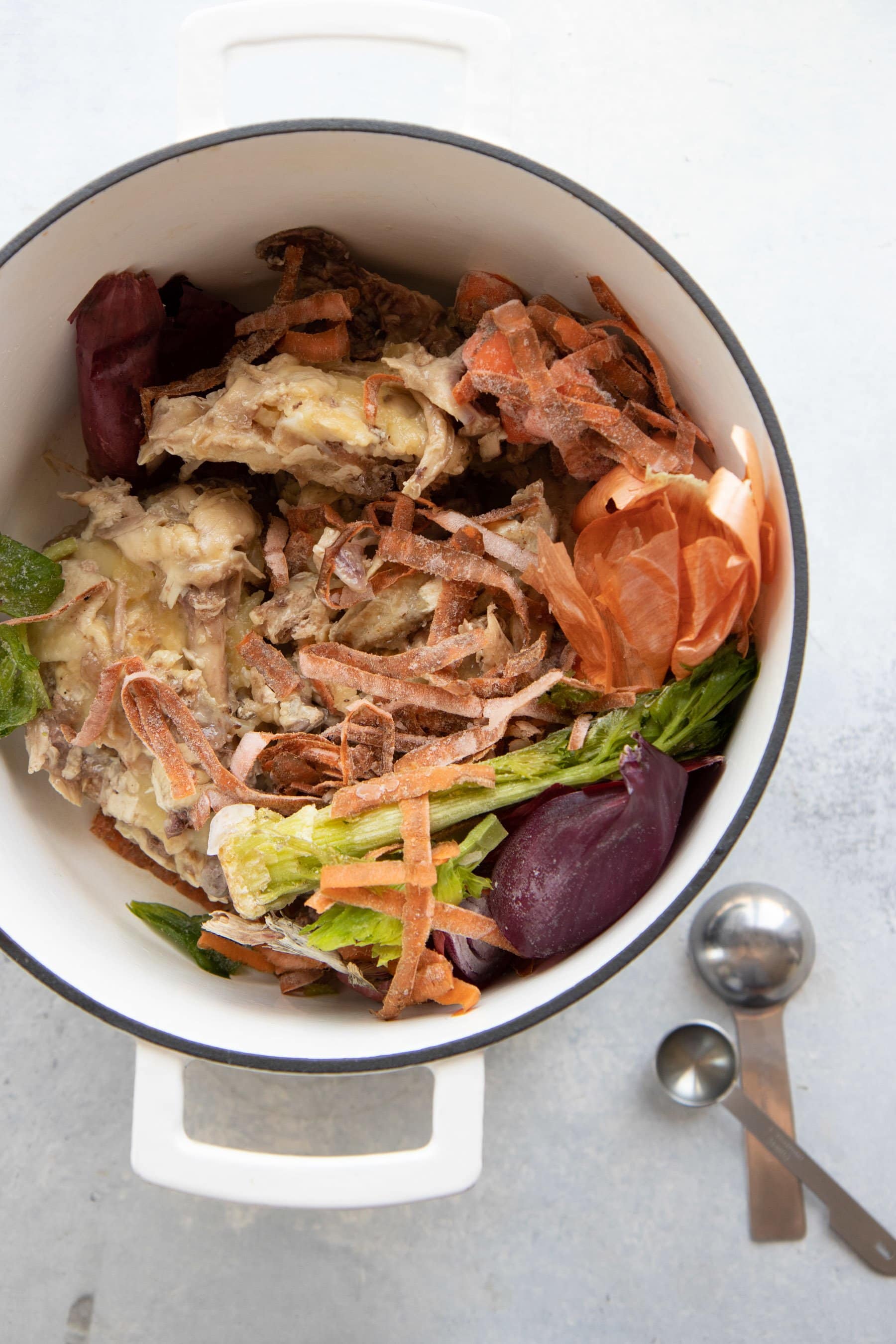 Overhead shot of ingredients for bone broth in a stockpot