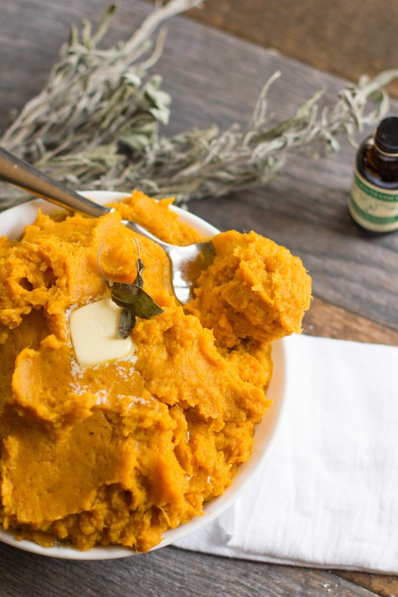 Bowl of brown butter mashed sweet potatoes on a folded white towel