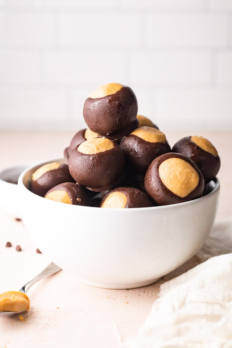 Close-up of a bowl piled high with chocolate peanut butter balls.