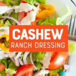 A white bowl is filled with a colorful salad dressed with paleo cashew ranch dressing. A text overlay reads "Cashew Ranch Dressing."