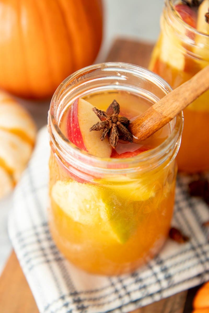 Close-up of a full glass of fall sangria in a glass jar.