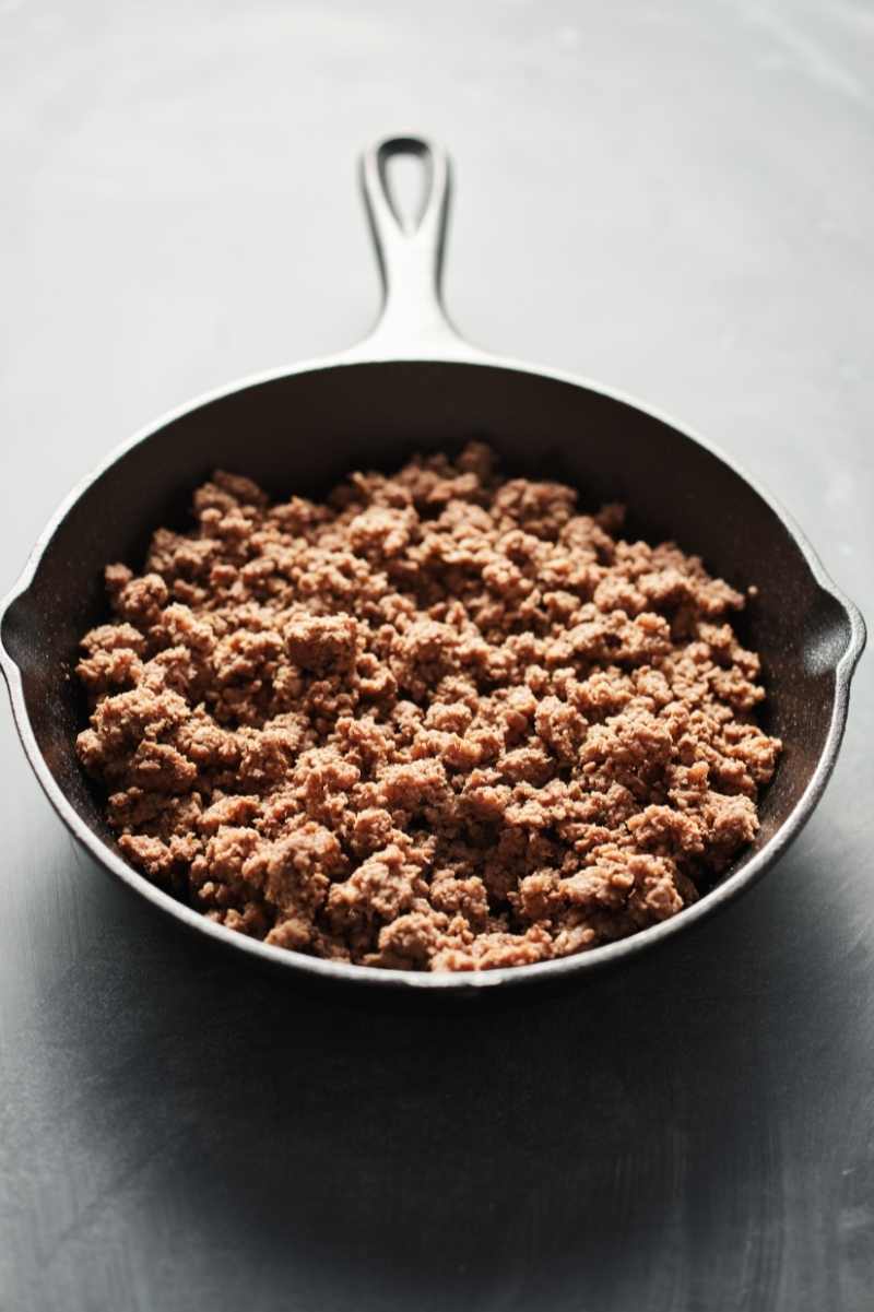 Top view of cooked beef in a cast iron skillet.