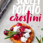 Assembled Sweet Potato Crostini with Goat Cheese and Pomegranate on a baking sheet lined with parchment paper. A text overlay reads "Sweet Potato Crostini."