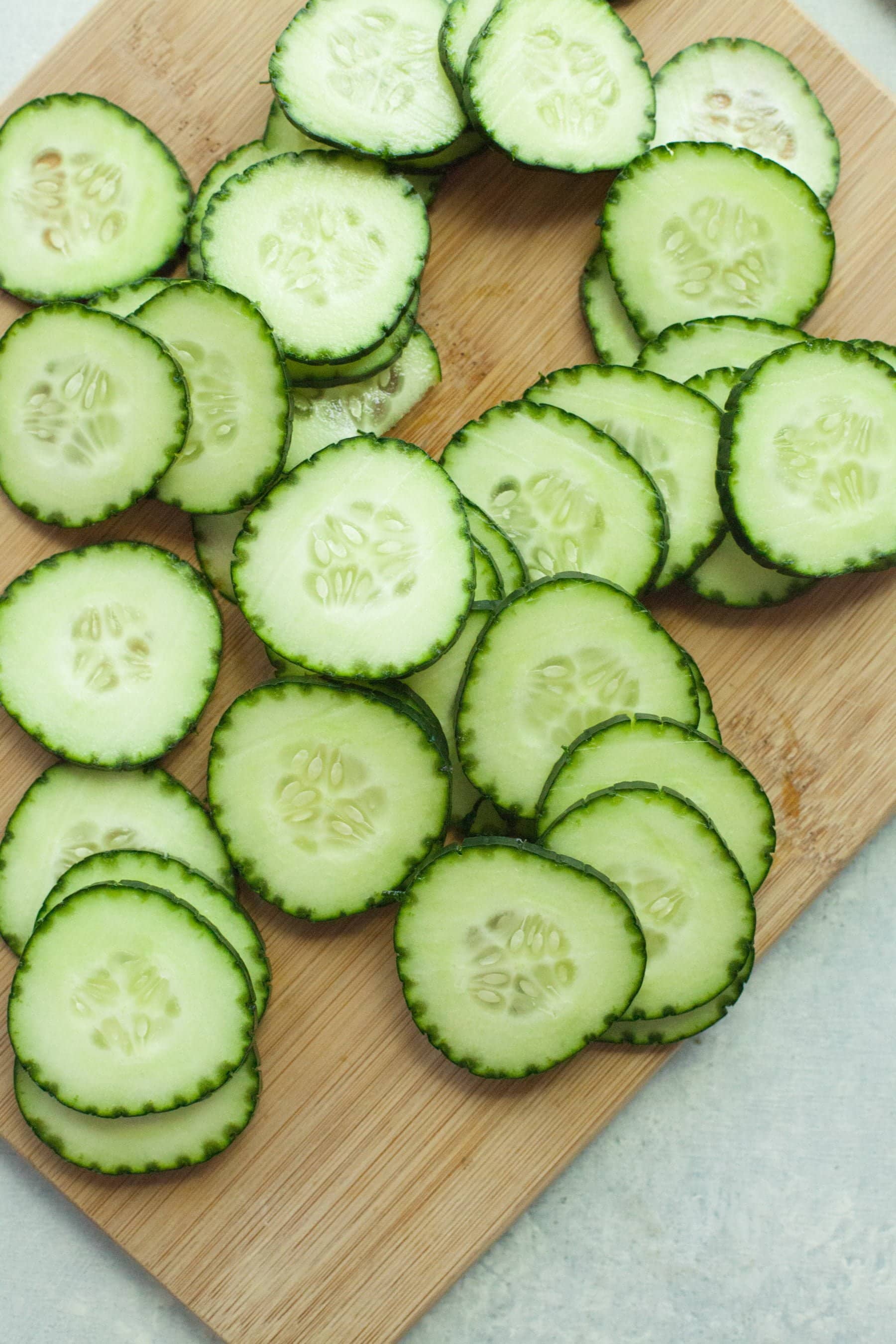 Sliced cucumbers on a cutting board.