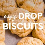 Tight view of tender, fluffy drop biscuits on a serving tray. A text overlay reads, "Easy Drop Biscuits."