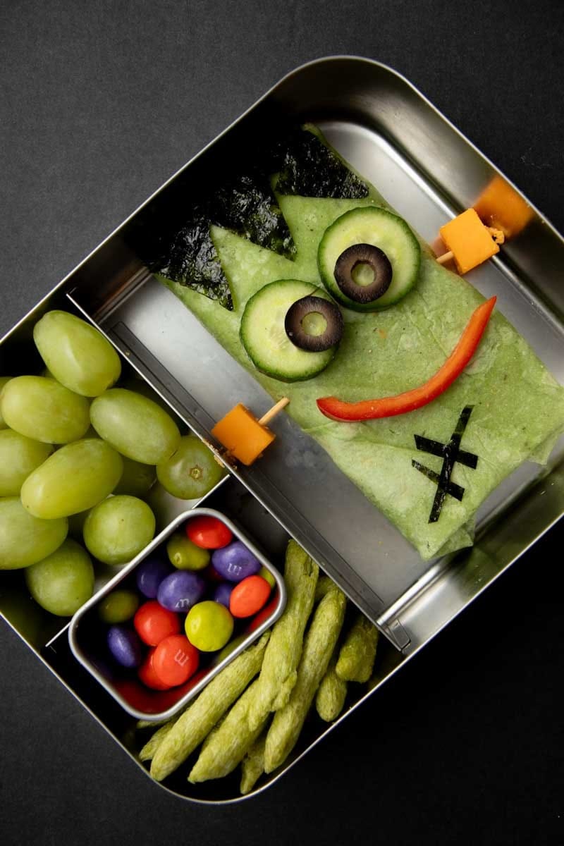 Close view of a Frankenstein wrap in a bento-style lunchbox.