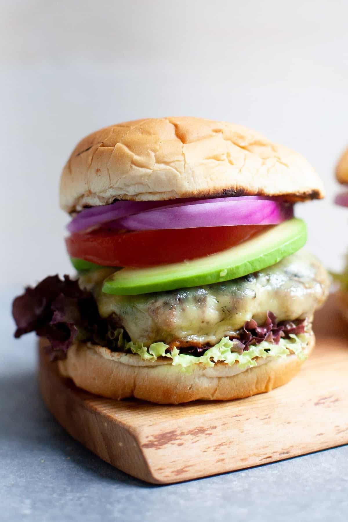 Close-up shot of a Garden Onion Burger on a cutting board