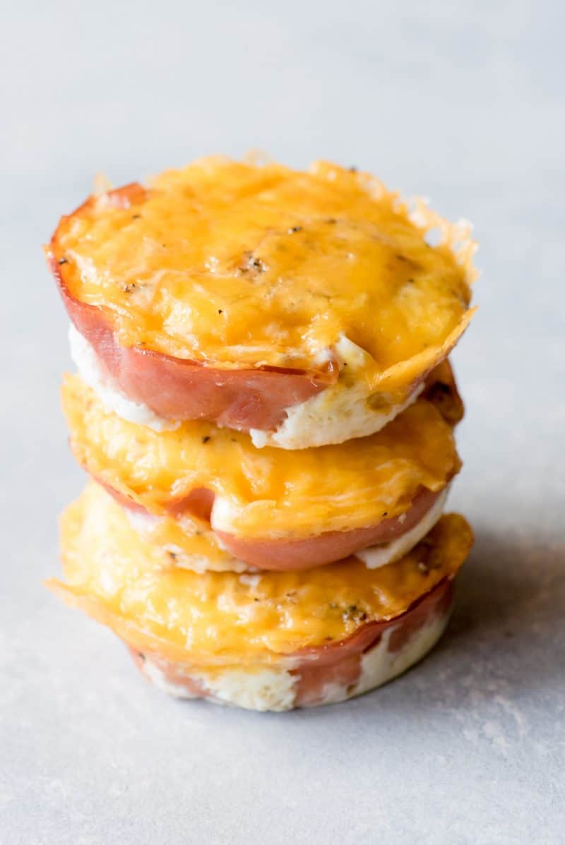 Three egg cups are stacked on a gray countertop.