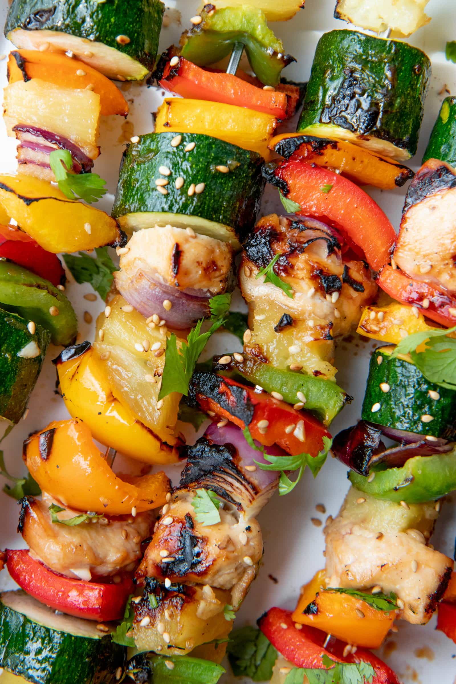 Close up of Grilled Chicken Kabobs on a white background