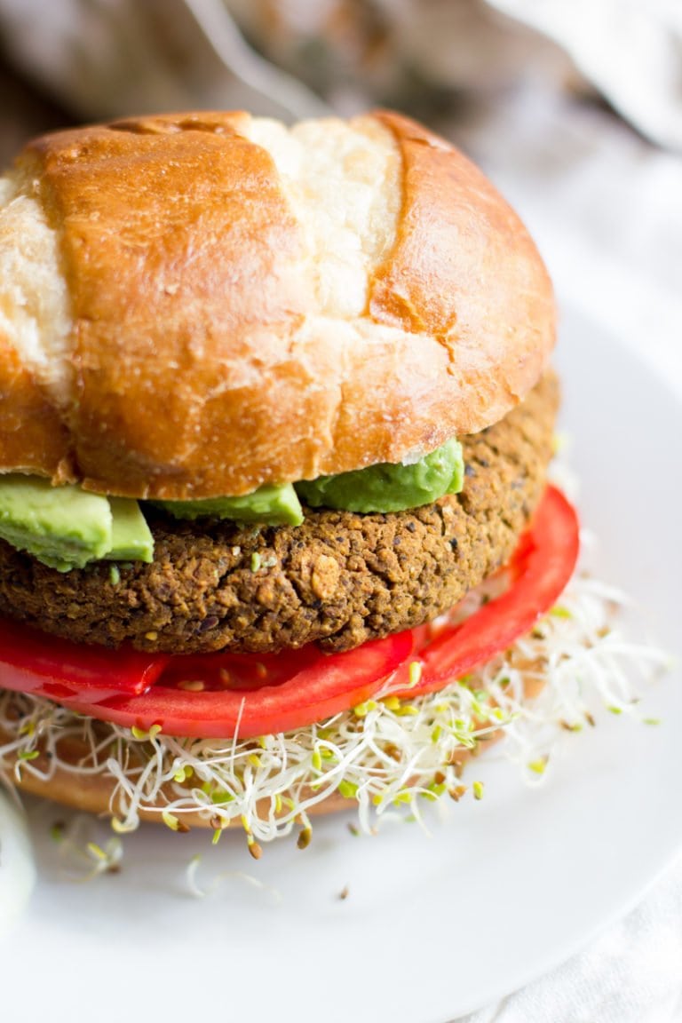 Pumpkin Black Bean Burger sits on a white plate.