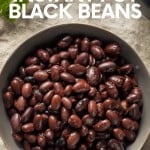 Overhead of a bowl of no soak black beans with fresh cilantro nearby. A text overlay reads, "No Soak! Instant Pot Black Beans."