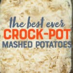 An overhead view of mashed potatoes in the basin of a slow cooker. A text overlay reads "The Best Ever Crock-Pot Mashed Potatoes."