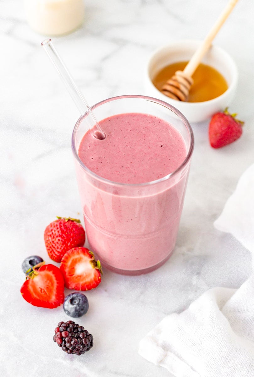 Mixed berry smoothie with fresh strawberries, blueberries, and blackberries.