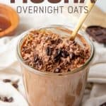 A gold spoon sits in a jar full of mocha overnight oats. A text overlay reads "Mocha Overnight Oats."