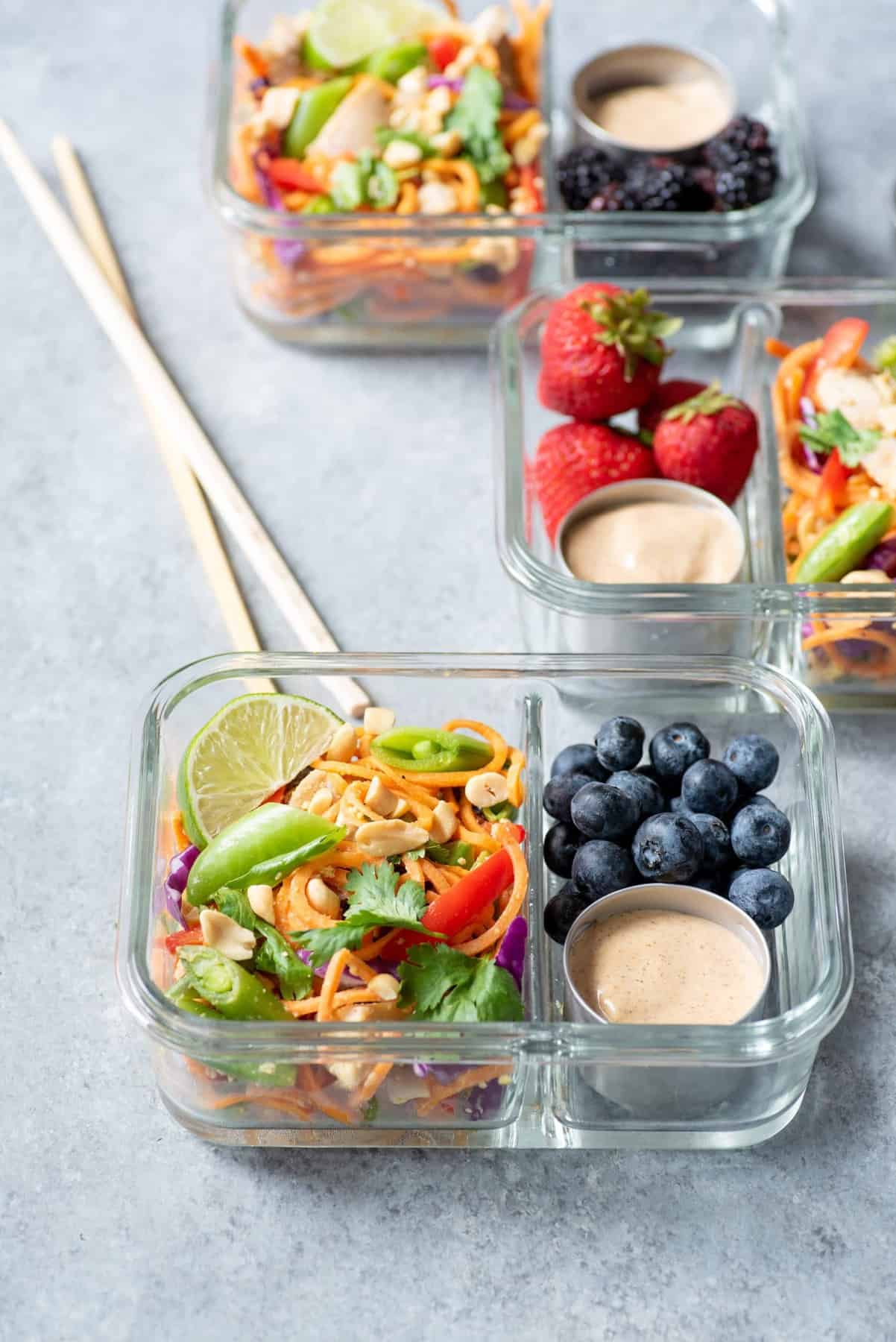 Side angle shot of Meal Prep Chicken Pad Thai with Sweet Potato Noodles packed into 3 glass lunch containers