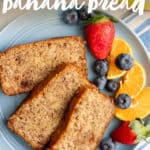 Three slices of almond flour banana bread on a blue plate with mixed fruit, next to a cup of coffee. A text overlay reads "Paleo Banana Bread."