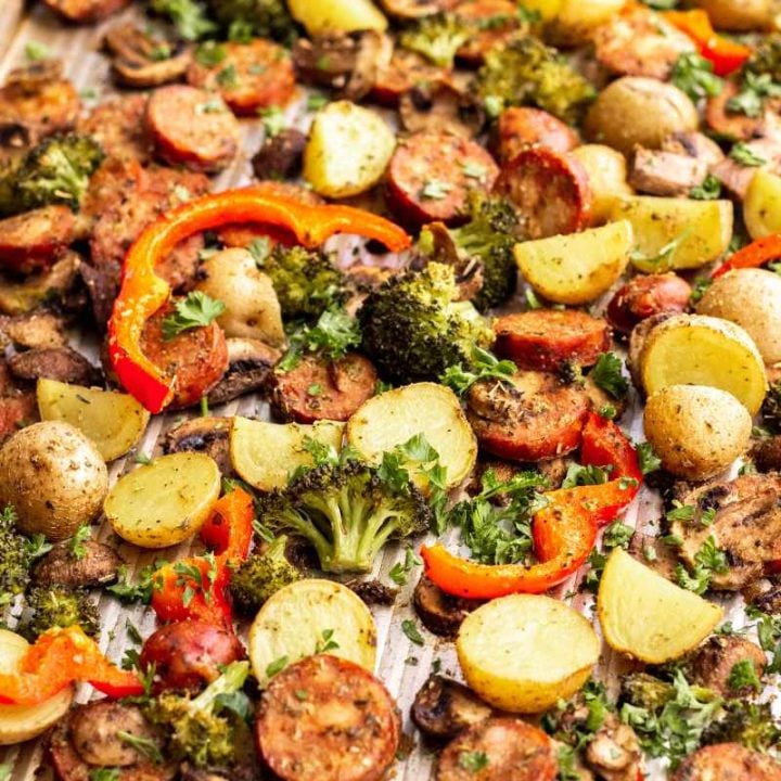 A sheet pan meal of perfectly roasted sausage and veggies ready to serve.