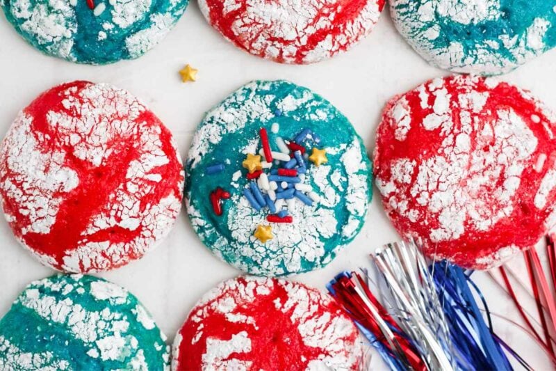 Top view of patriotic red and blue cookies with white crackled powdered sugar tops.