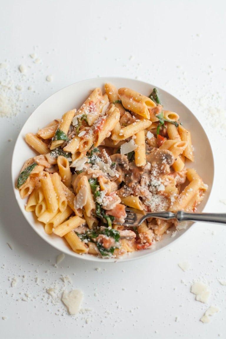 A bowl of Penne Rosa with shrimp and parmesan cheese.