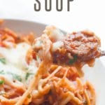 Slow Cooker Lasagna Soup sits in a bowl. A text overlay reads "slow cooker lasagna soup"