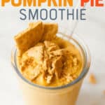 Pumpkin smoothie in a clear glass with a straw on a white background. The smoothie is garnished with graham cracker pieces. A text overlay reads "Healthy Pumpkin Pie Smoothie."