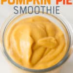 Pumpkin smoothie in a clear glass on a white background. A text overlay reads "Healthy Pumpkin Pie Smoothie."