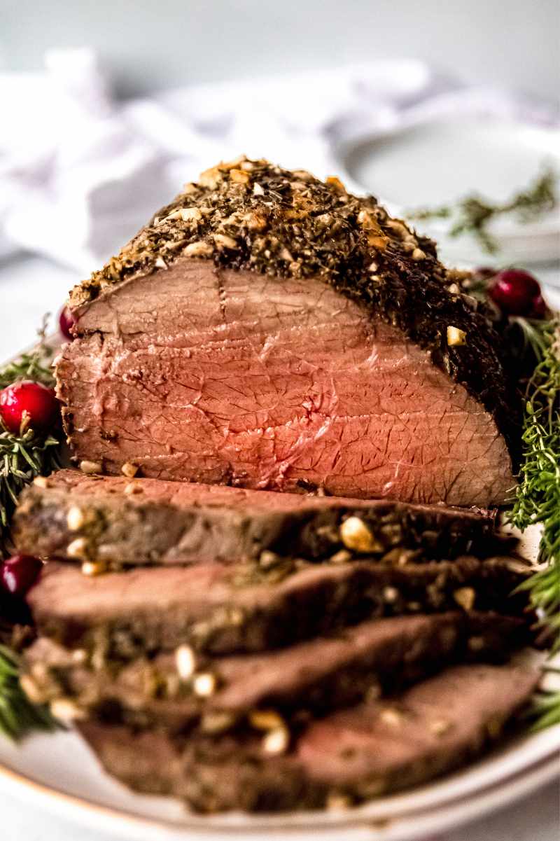 Close view of the juicy and tender pink center of a roast beef dinner, sliced and ready to eat.