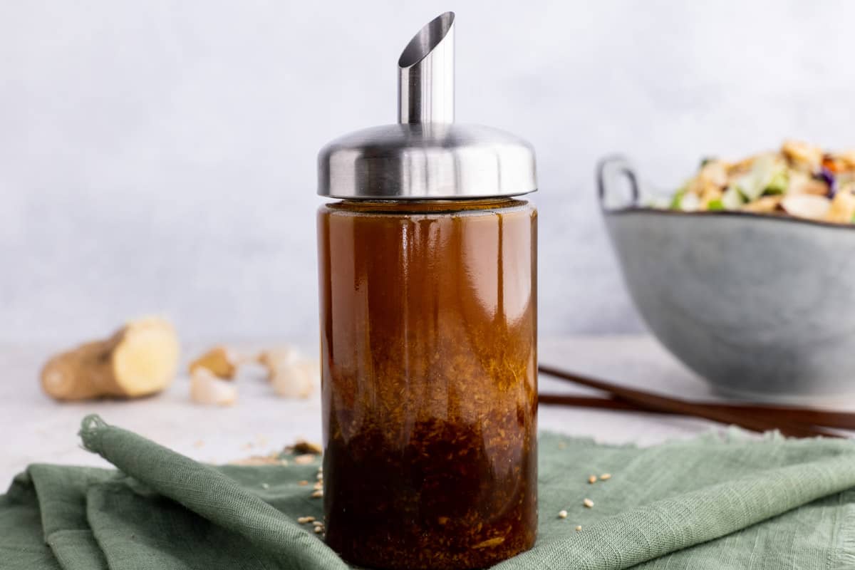 Close view of sesame ginger salad dressing in an easy pour bottle.