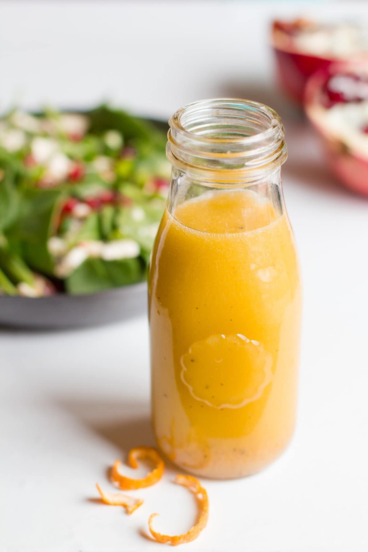 A small glass jar holds homemade clementine vinaigrette.