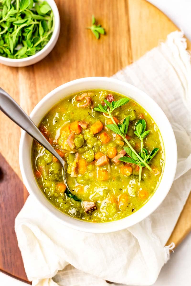 Overhead of split pea and ham soup in a bowl with a spoon in it.