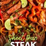 Bright lime wedges rest on a tray of steak fajitas with colorful peppers, onions, and chopped cilantro. A text overlay reads, "Sheet Pan Steak Fajitas."