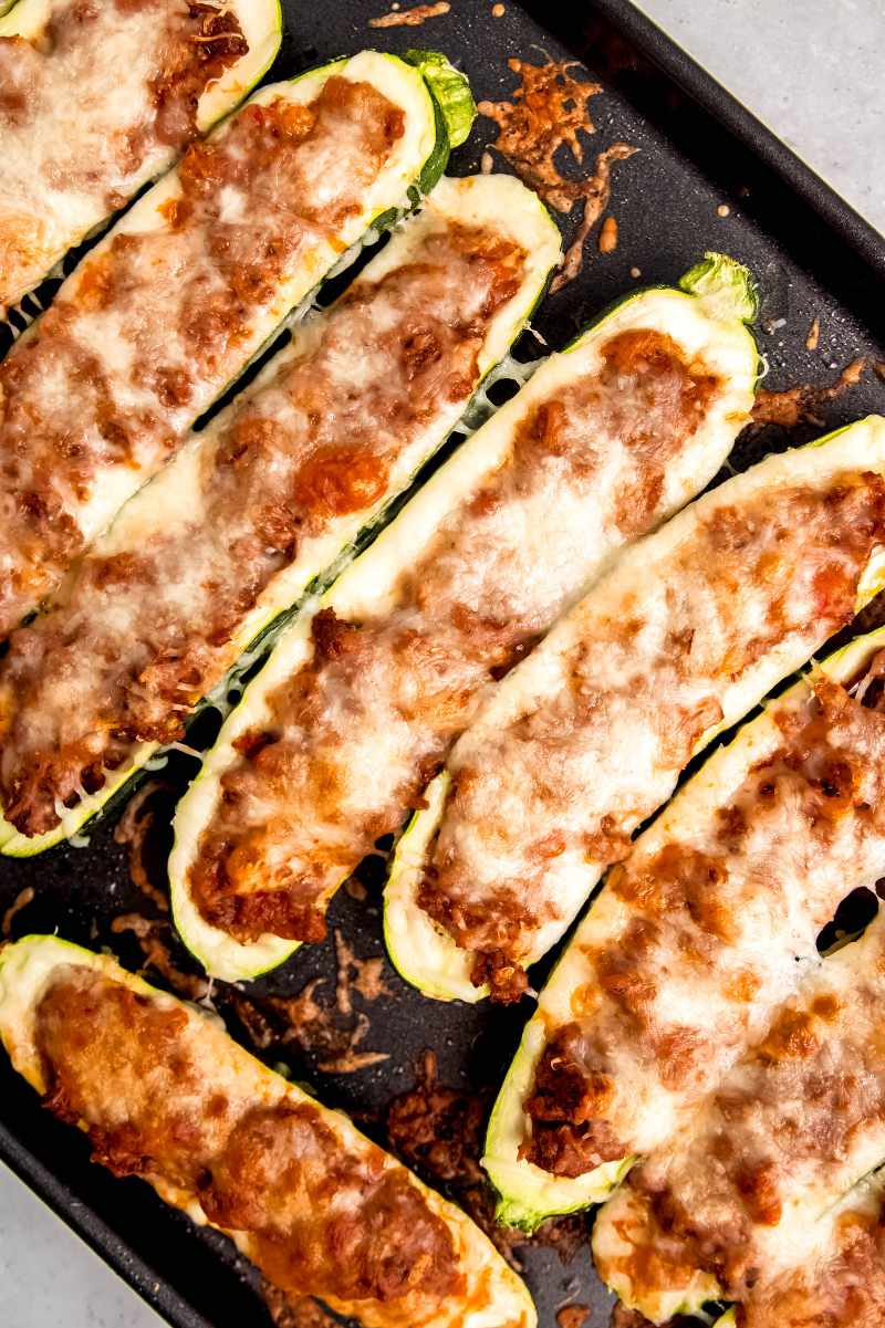 Close view of stuffed squash on a baking sheet.