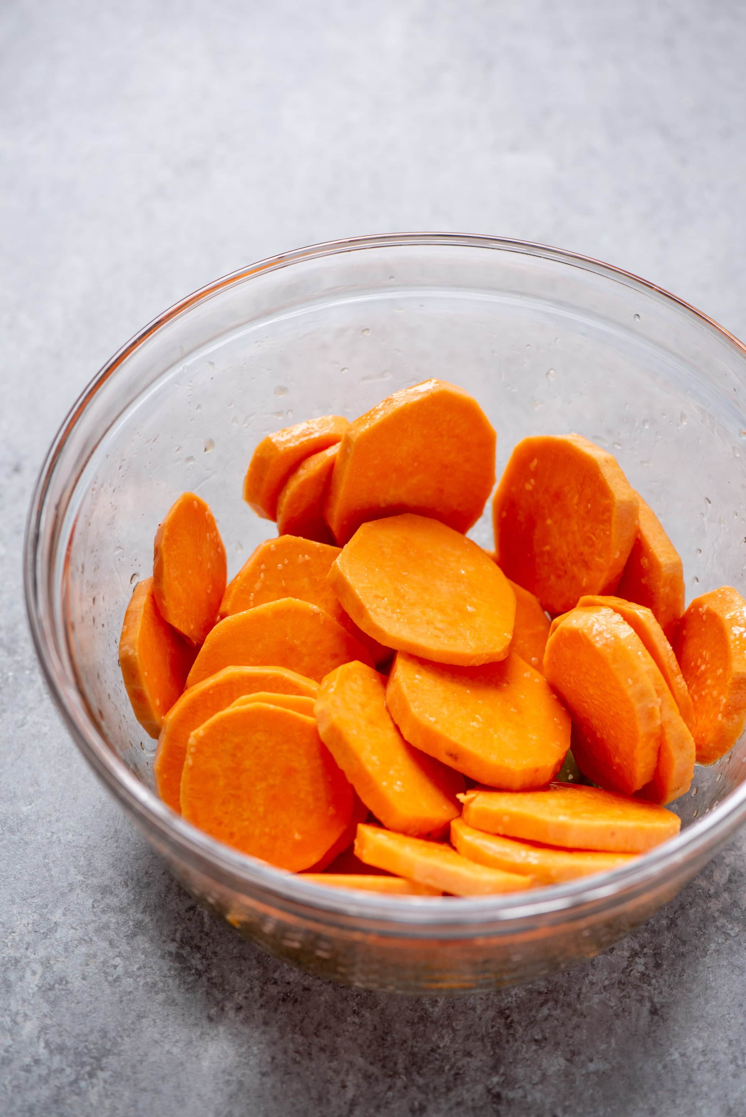 Sweet potato slices in a clear glass bowl