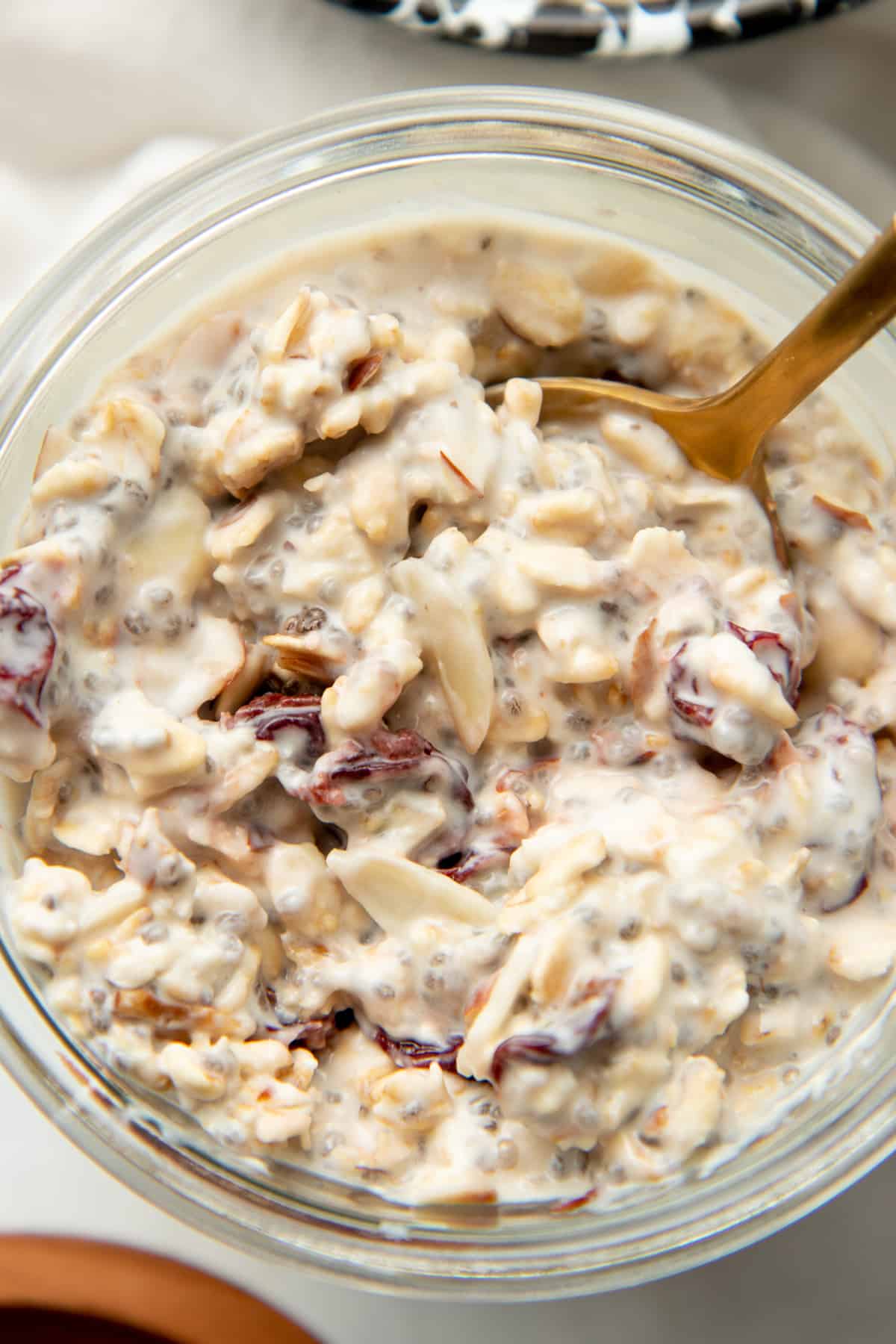 A spoon scoops in to a jar of overnight oats.