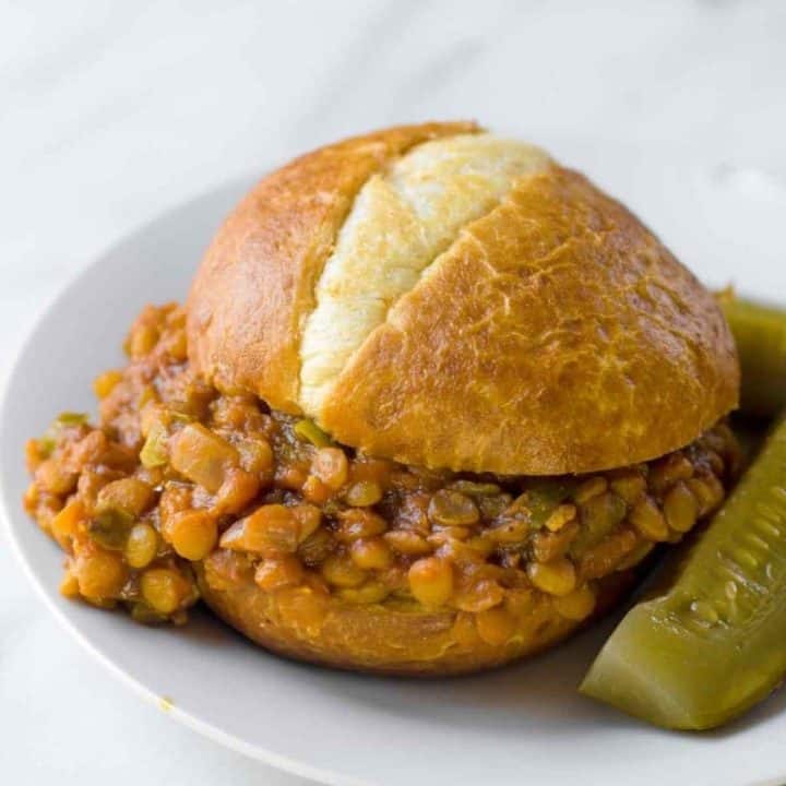 A finished sloppy joe sits on a plate.