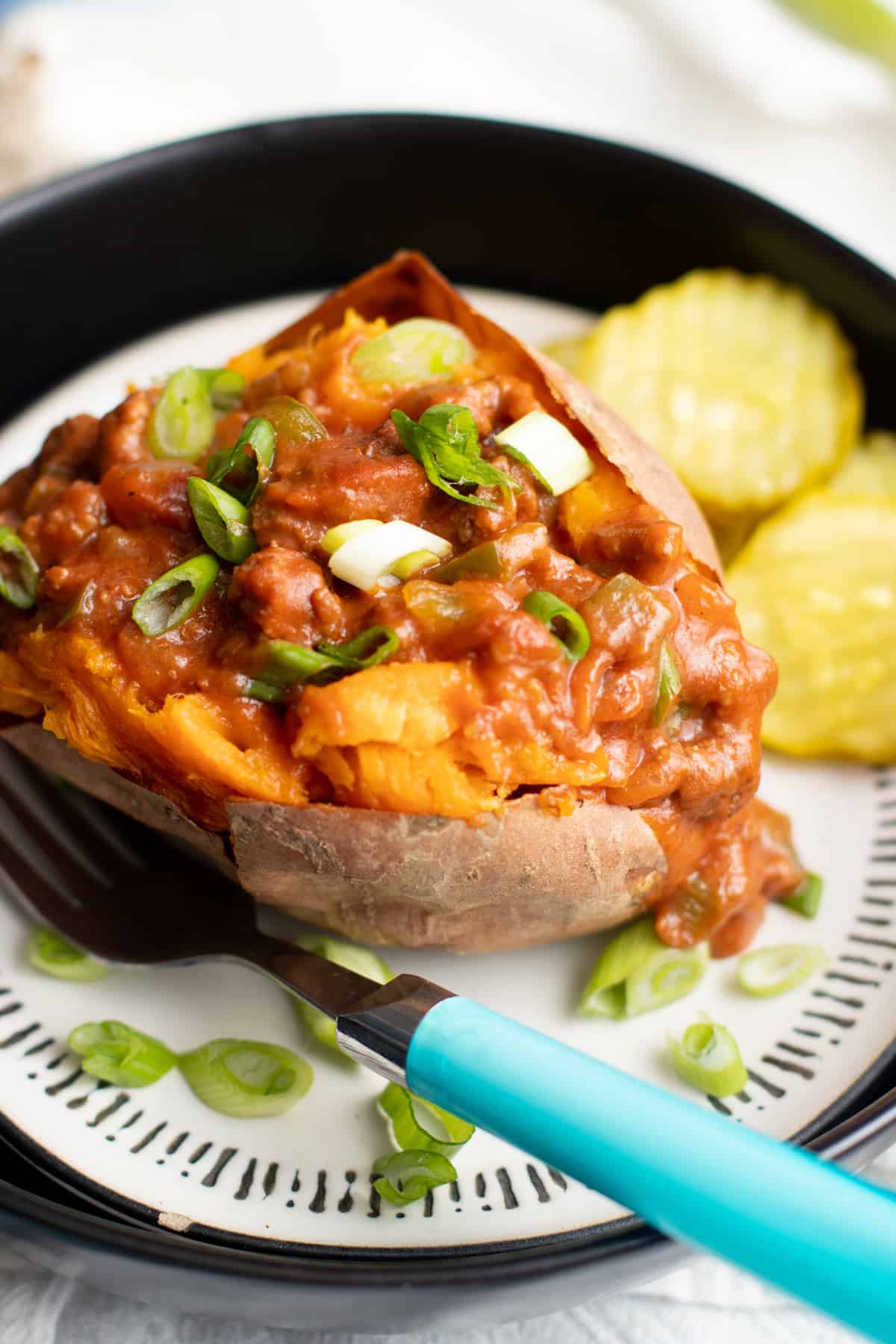 Sweet potato stuffed with Sloppy Joes filling and topped with sliced green onions.